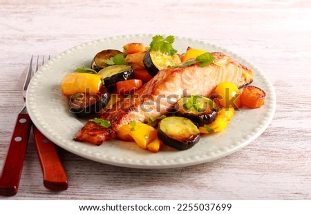 Pescatarian dinner - roast salmon with vegetables on plate Royalty-Free Stock Photo #2255037699