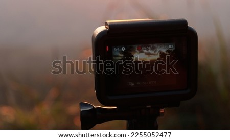 Sunset landscape through screen camera.