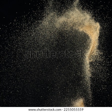 Sand flying explosion, Golden sand wave explode. Abstract sands cloud fly. Yellow colored sand splash throwing in Air. black background Isolated high speed shutter, throwing freeze stop motion Royalty-Free Stock Photo #2255055559