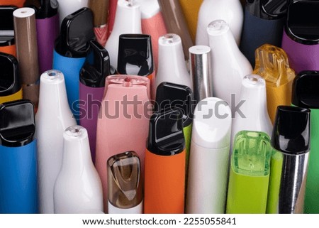 Close up Synthetic nicotine concept. Various disposable electronic cigarettes. modern alternative smoking, vaping and nicotine. Royalty-Free Stock Photo #2255055841