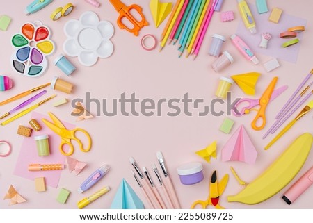 Pink pastel background with various colorful material for creativity and art activity.  Stationery and supplies for drawing and craft with 
copy space.  Primary School or kindergarten. Royalty-Free Stock Photo #2255089725