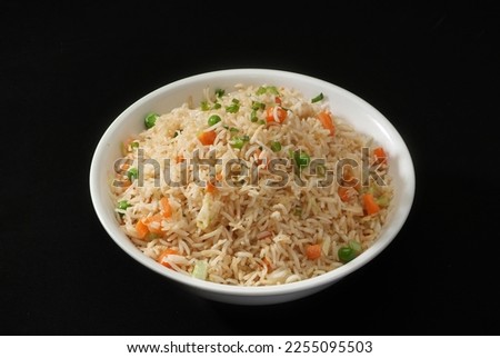 Veg Fried Rice, Is a popular Japan-Chinese delicacy all over Arabs, Chinese cuisine pictures, isolated on Black background.