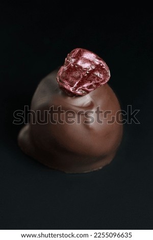 Dessert Styled Close Up. Chocolate Truffle Detail. Valentine's Day Dessert. Chocolate Candy against Dark Background. Dramatic Close Up of Candy.