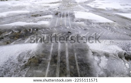 Snowy street with car marks, dangerous and slippery road