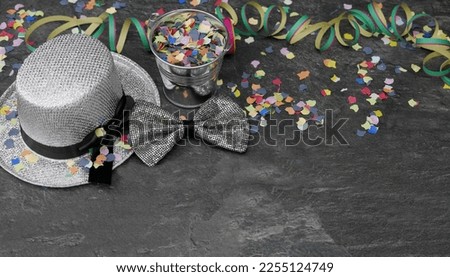 Carnival accessories on dark background with space for text.