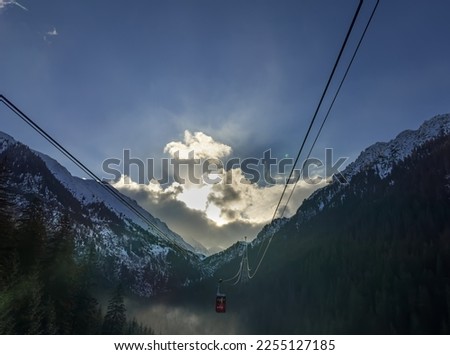 Cable car coming through the mountains, winter morning, Carpathian mountains, Romania