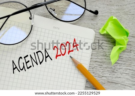 AGENDA . Copy space. open notebook with glasses with text on the corner of the notebook.