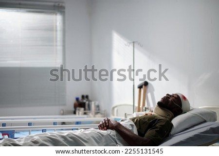 Sick military man resting in hospital ward after head surgery