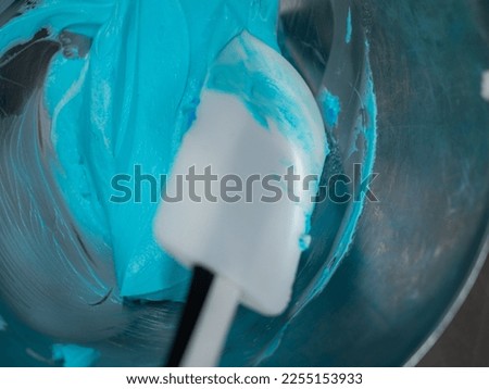 turquoise icing piping filling for frosted cake decoration in kitchen lab
