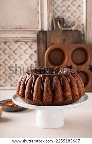 Chocolate marble bundt cake or zebra cake with chocolate glaze drizzled on top freshly baked