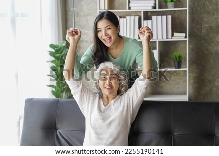 Candid attractive beautiful mum sit at cozy sofa couch living room in family moment grown child kid celebrate joy good warm time kiss relationship with retired overjoy lady girl health life.