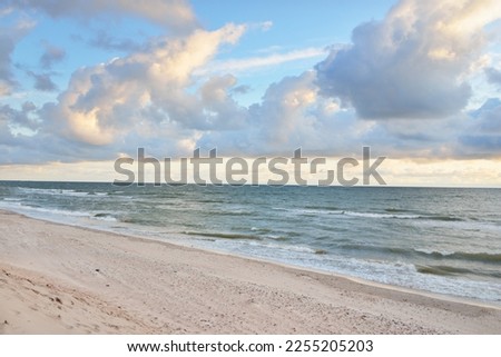 Baltic sea shore (sand dunes, beach) after the storm. Sunset, soft golden sunlight, glowing clouds. Picturesque panoramic scenery. Nature, environment, ecology, ecotourism, hiking, exploring concepts Royalty-Free Stock Photo #2255205203
