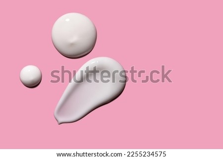 Skin care cream, face serum swatch smear on pink background. Skincare product creamy texture smudge swipe closeup.  Royalty-Free Stock Photo #2255234575