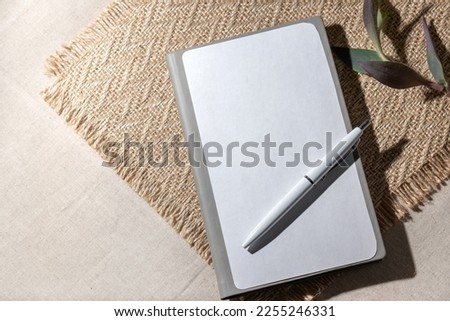 Blank paper notebook sheet with mockup copy space on beige background. Flat lay, top view minimalist business brand template