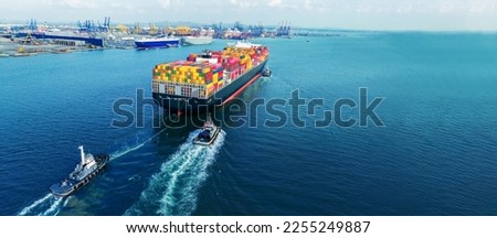 Tub Boat with Stern of cargo ship carrying container and running for import goods from cargo yard port to custom ocean concept technology transportation , customs clearance. 