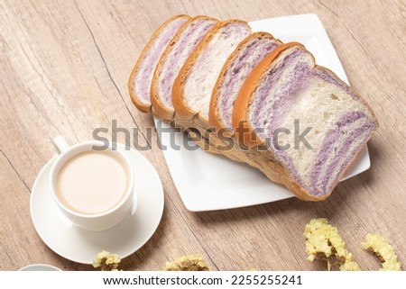 Sliced bread with taro and coffee on wooden background