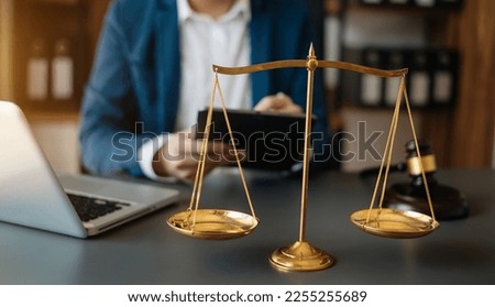 Male lawyer in the office with brass scale on wooden table. justice and law concept in morning light