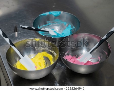 pink icing piping filling for frosted cake decoration in kitchen lab