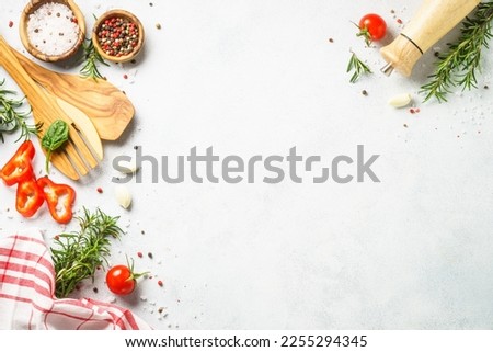 Food background with spices, herbs and utensil on white background.