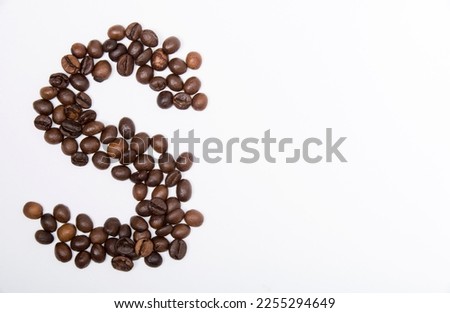 S is a capital letter of the English alphabet made up of natural roasted coffee beans that lie on a white background. Plenty of space to put text or pictures, top view and studio photography.