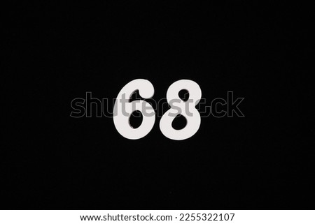 white numbers on a black background Made of wood sprayed with white spray paint.