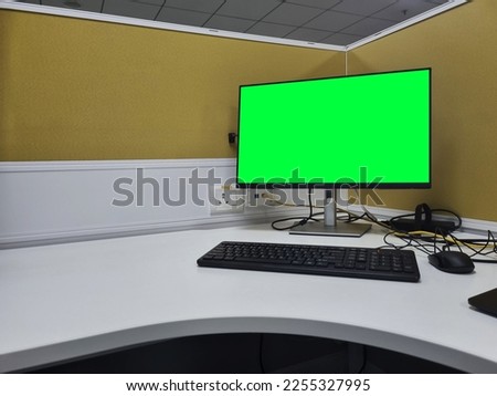 green screen desktop monitor on workstation with copy space in cubicle Royalty-Free Stock Photo #2255327995