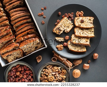 Tasty traditional homemade biscotti biscuits on black table background. Delicious cantucci cookies with nuts and raisin. Royalty-Free Stock Photo #2255328237