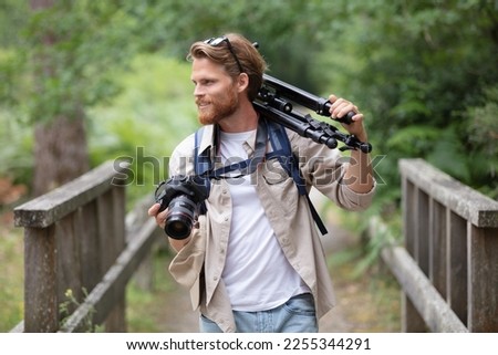 professional nature photographer walking in the forest
