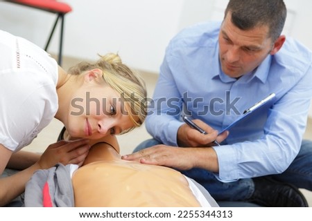 woman listening for breath during first aid training course Royalty-Free Stock Photo #2255344313