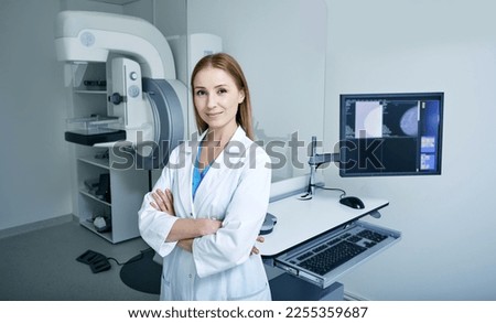 Experienced female radiologist standing near mammography workstation at radiology room of hospital. Mammography, mammogram Royalty-Free Stock Photo #2255359687