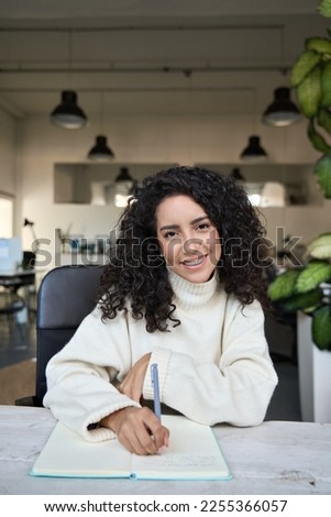 Smiling young business woman office worker, student, hr manager looking at web camera having online job interview, remote video call or leading work webinar sitting in office, vertical portrait. Royalty-Free Stock Photo #2255366057