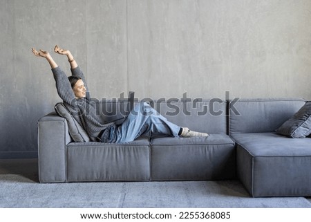 Woman sit on sofa put pc on lap clenched fists scream with joy while read great news on laptop. Gambler celebrate online auction bet victory. Got incredible offer sincere emotions of happiness concept Royalty-Free Stock Photo #2255368085