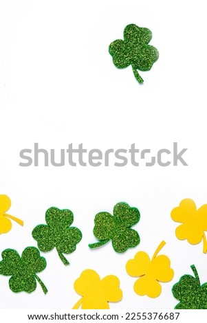 Happy St. Patrick's Day banner.Holiday background.St Patricks Day frame against a white background. Flat lay shamrocks.Copy space.Patrik's day banner Royalty-Free Stock Photo #2255376687