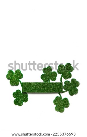 Happy St. Patrick's Day banner.Holiday background.St Patricks Day frame against a white background. Flat lay shamrocks.Copy space.Patrik's day banner Royalty-Free Stock Photo #2255376693