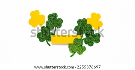 Happy St. Patrick's Day banner.Holiday background.St Patricks Day frame against a white background. Flat lay shamrocks.Copy space.Patrik's day banner Royalty-Free Stock Photo #2255376697