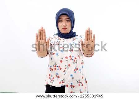 Asian muslim woman standing with rejected hand gesture. Isolated on white background