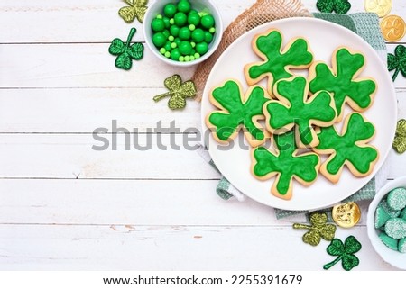 St Patricks Day shamrock cookies. Top view table scene on a white wood background with copy space.