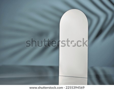 Mirror on a blue background with natural shadows