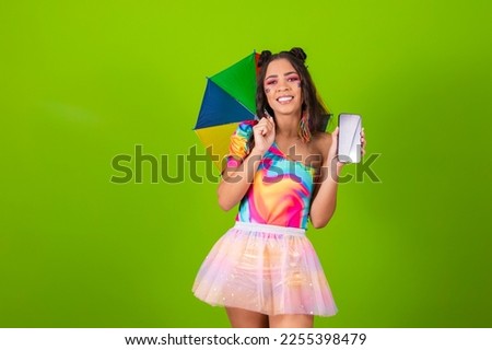 Beautiful woman dressed in carnival outfit holding a smartphone with a blank screen for carnival advertisement