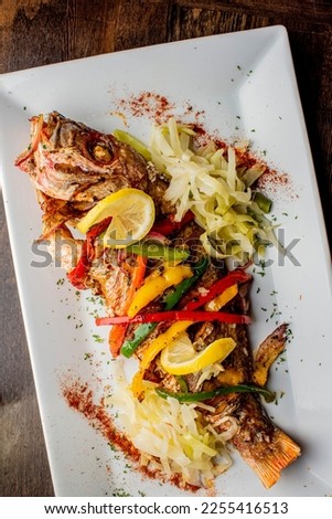 Grilled fish. Grilled red snapper. Traditional Classic American or French Seafood Restaurant menu item, whole grilled fresh caught halibut or sea bream Fish served with chilled gazpacho and peppers.