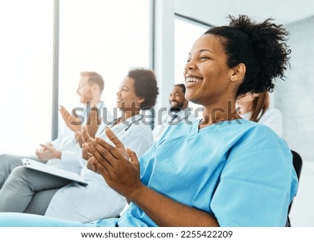 Portrait of a young doctors and nurses in audiance during a seminar in a board room or during an educational class at convention center  Royalty-Free Stock Photo #2255422209