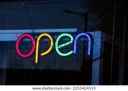 Colourful neon open sign on a window