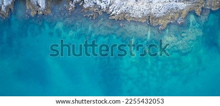Adriatic Sea. Croatia. An aerial view of a stony beach with delightful azure water. Through the thickness of the transparent water you can see the bottom.