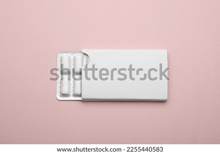 Blister with chewing gums on pink background, top view Royalty-Free Stock Photo #2255440583