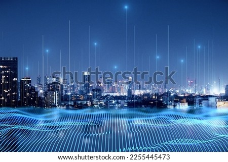 Smart city and big data connection technology concept with digital blue wavy wires with antennas on night megapolis city skyline background, double exposure Royalty-Free Stock Photo #2255445473