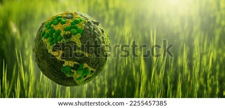 Green planet Earth from natural moss on a green grass background. Symbol of sustainable development and renewable energy Royalty-Free Stock Photo #2255457385