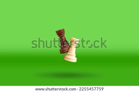 White and black chess rook floating above the green table. Advertising of a chess school with flying shapes. High quality photo