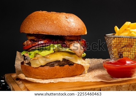 burger with fries on a dark background