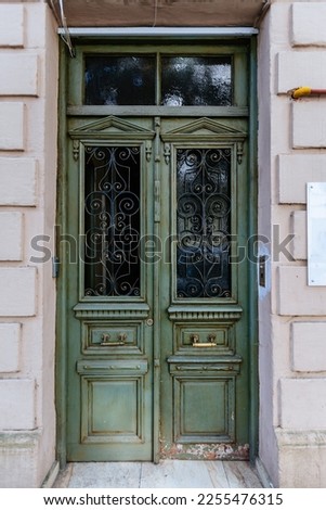 Vintage wooden green door of old mansion.