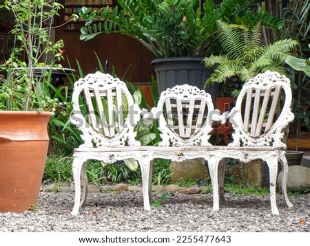 White vintage wooden chairs in the courtyard of a restaurant
